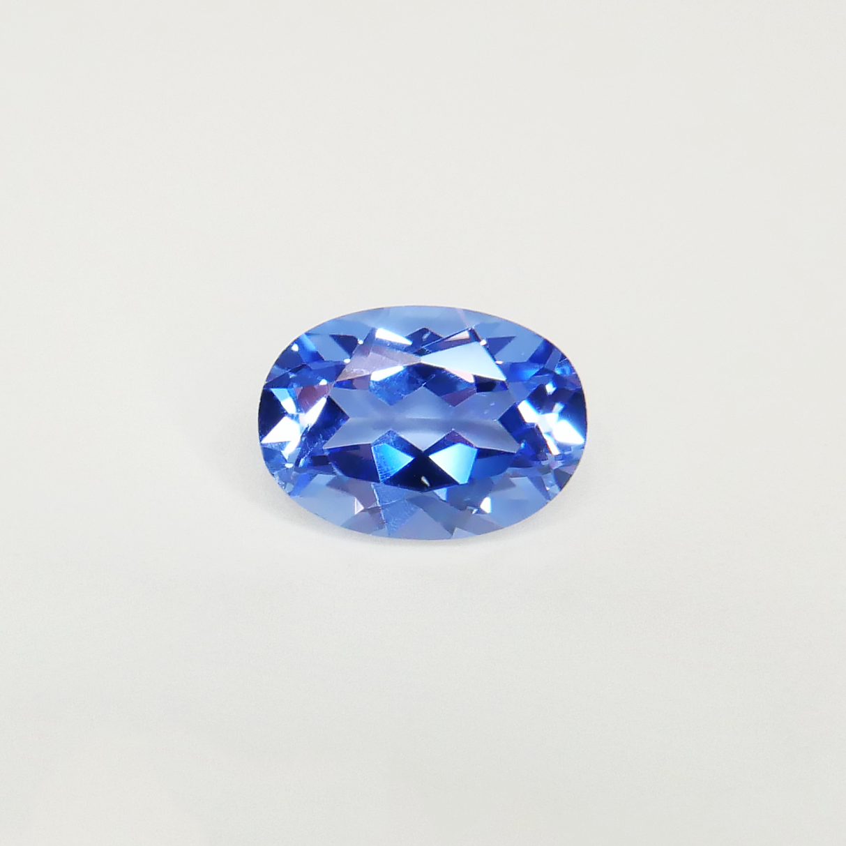 light blue oval hand-cut lab-grown sapphire